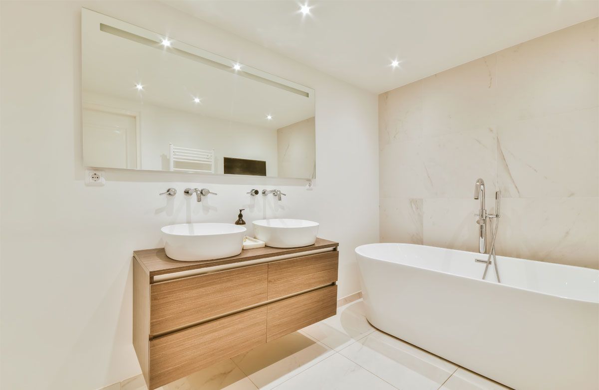 Double bathroom sinks next to a bathtub