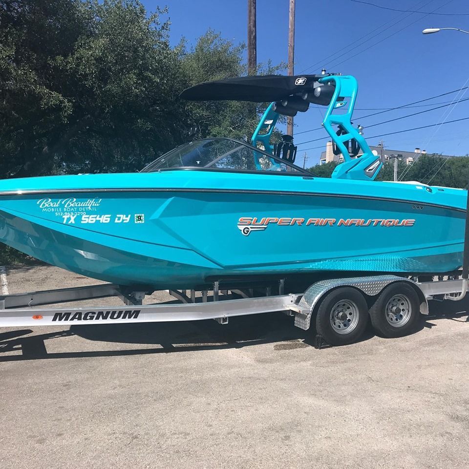 A blue boat is on a magnum trailer