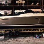 A boat is sitting on a trailer in a garage.