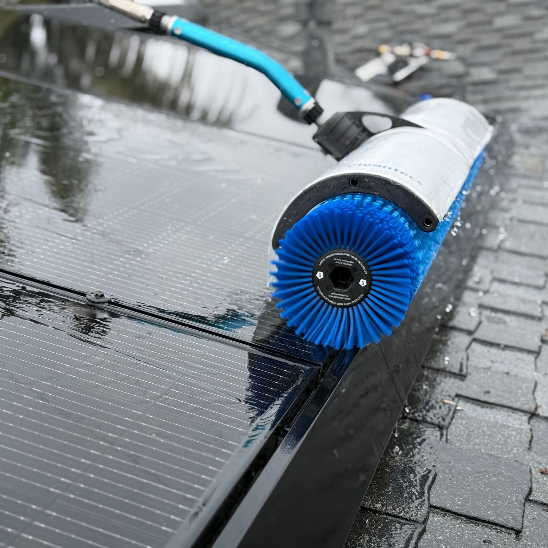 NFG Solar Panel Cleaning Company - A blue brush is being used to clean a solar panel
