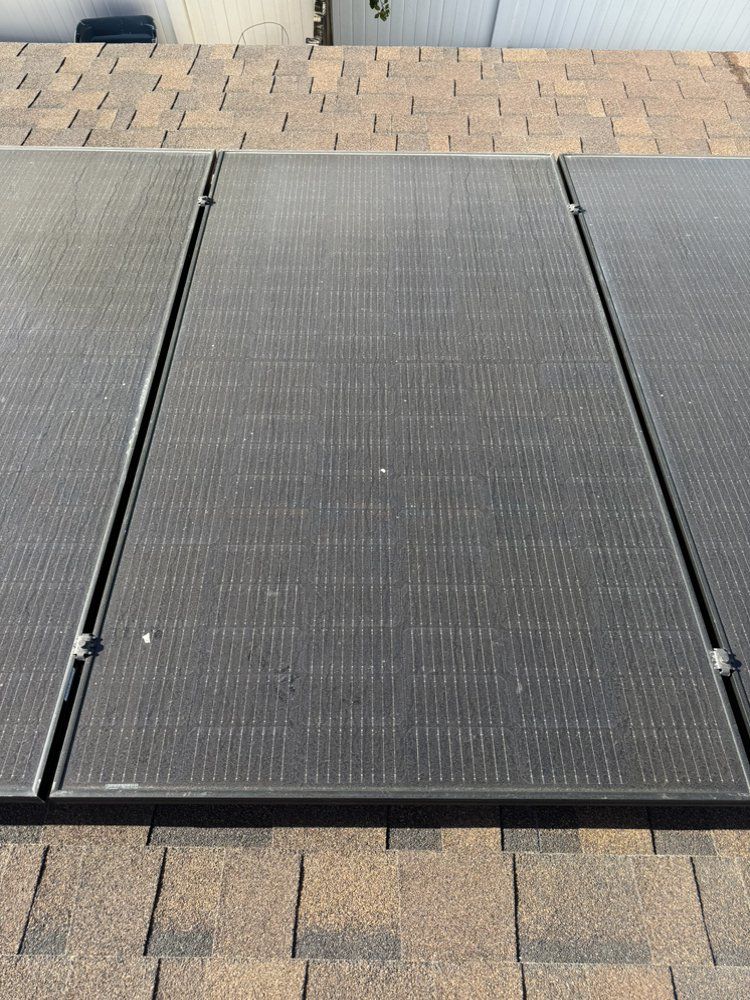 NFG Solar Panel Cleaning Company - A solar panel is sitting on top of a roof.