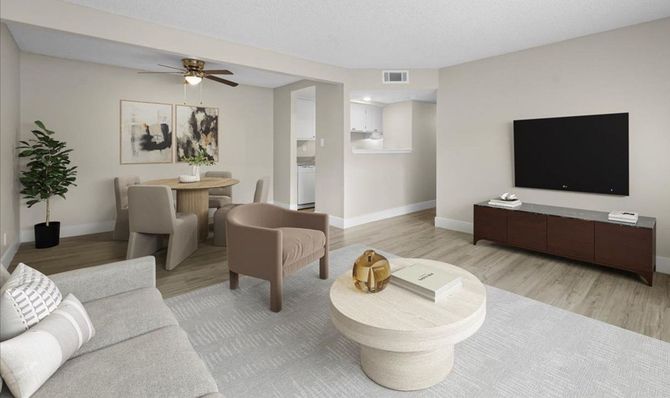 Spacious living room with large windows at Sherwood Forest Apartments