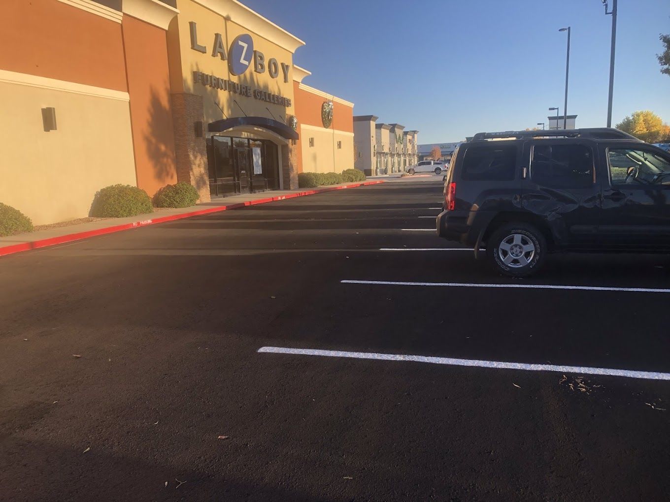 A car is parked in front of a la z boy store
