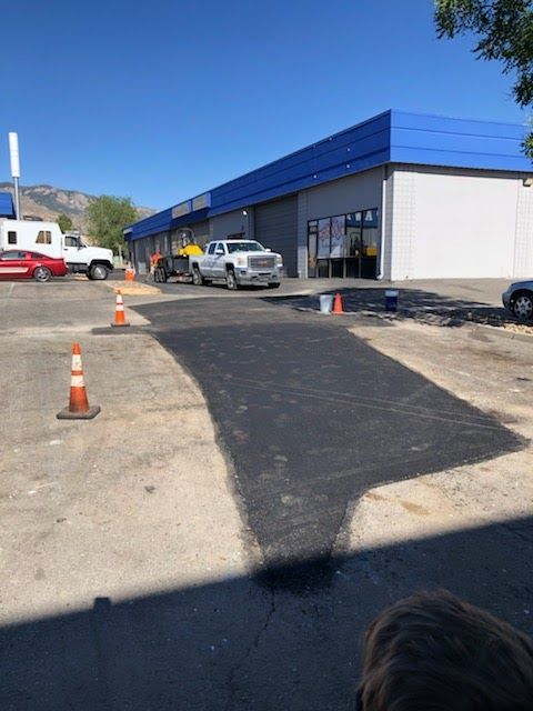 A white truck is parked in front of a building