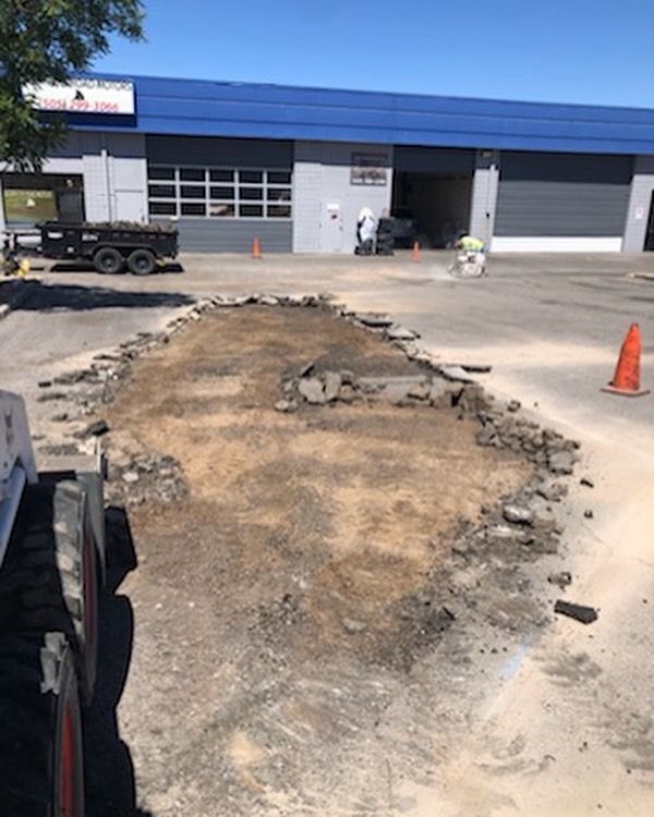 A construction site with a blue building in the background