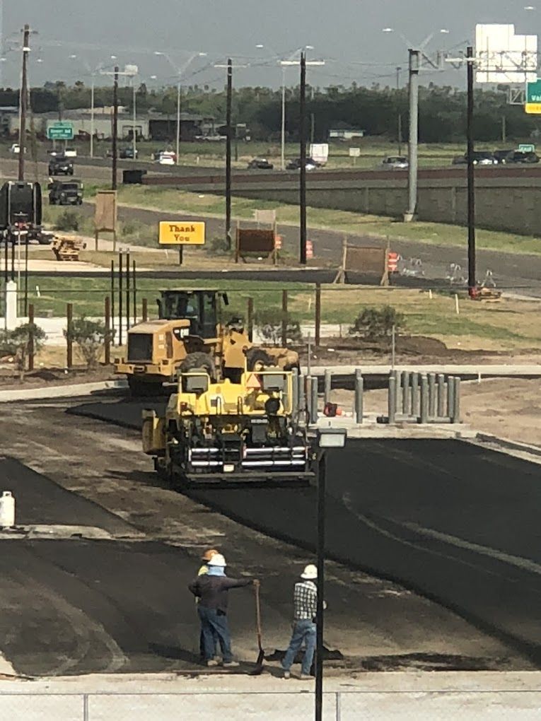A group of construction workers are working on a road