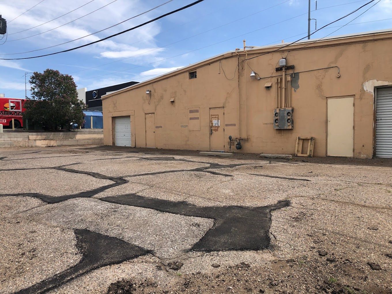 An empty parking lot with a building in the background