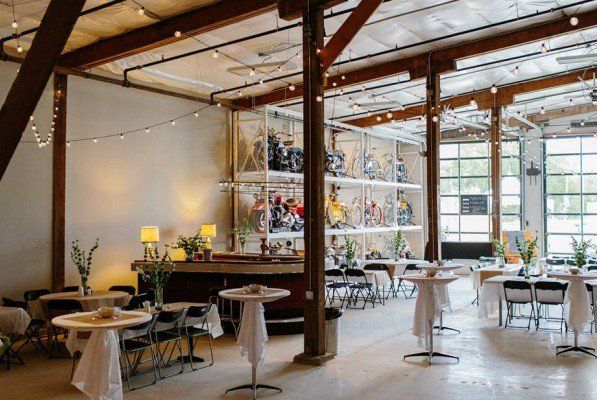 A large room with tables and chairs set up for a party.