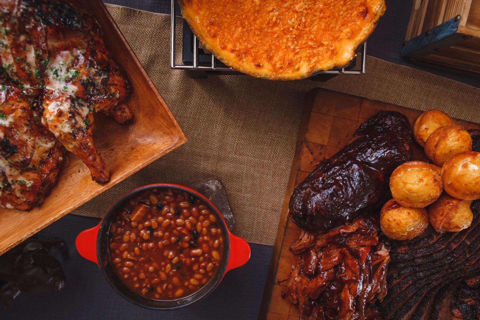 A table with flowers and plates on it with a rustic farm background.