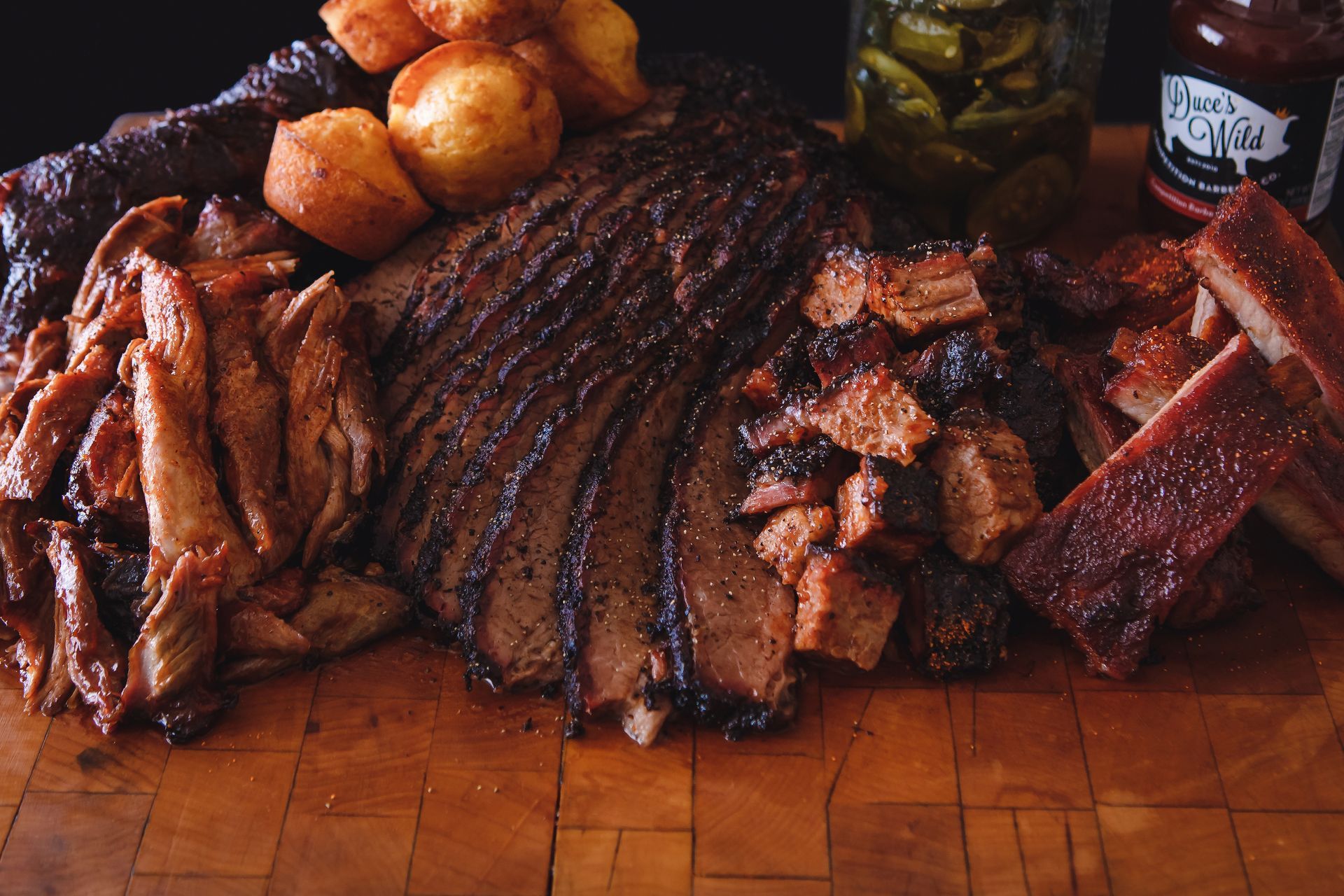 mac n cheese, barbecue ribs and chicken, and lemonade on a striped tablecloth. 
