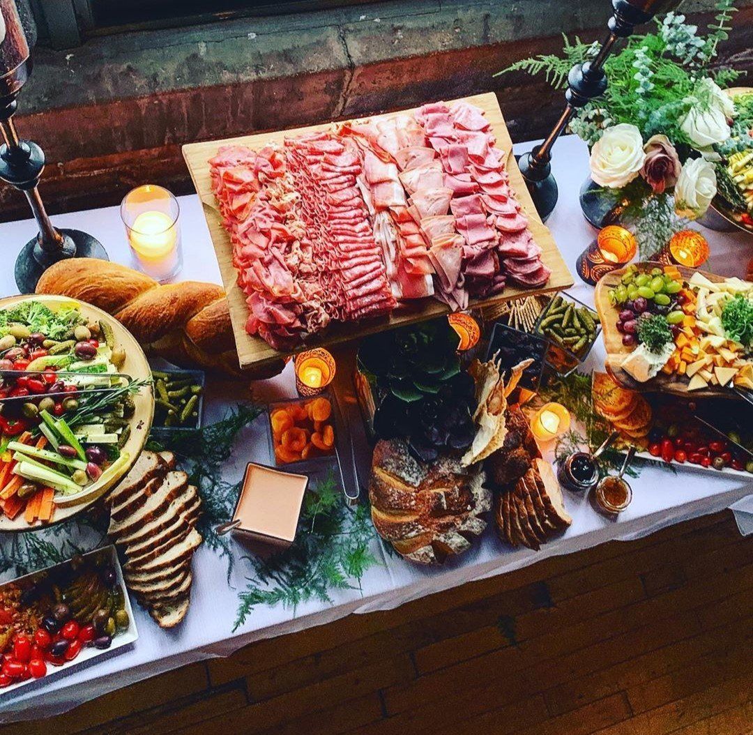 A table topped with a variety of food including meat and vegetables.