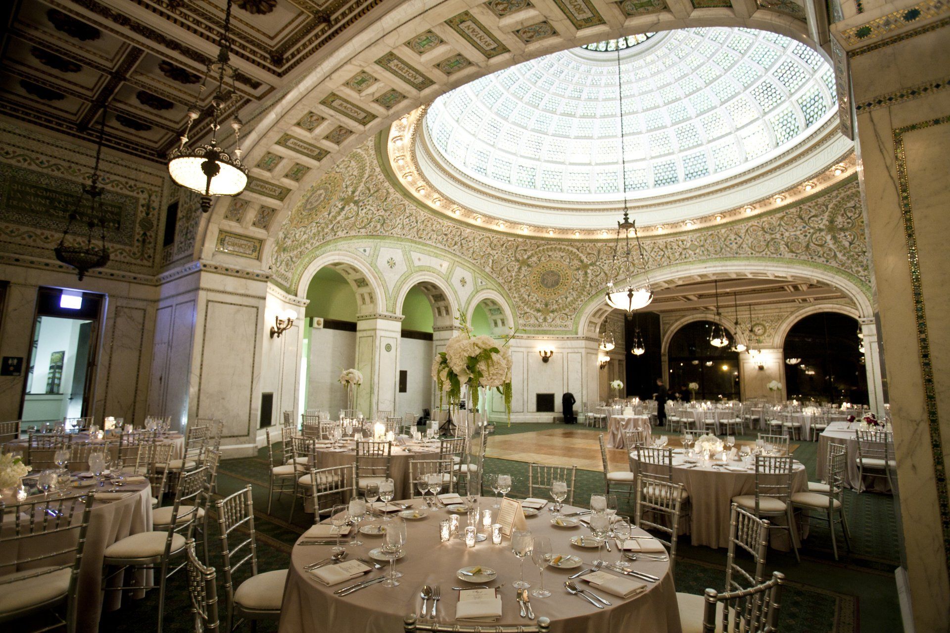 A large room with tables and chairs and a dome in the ceiling