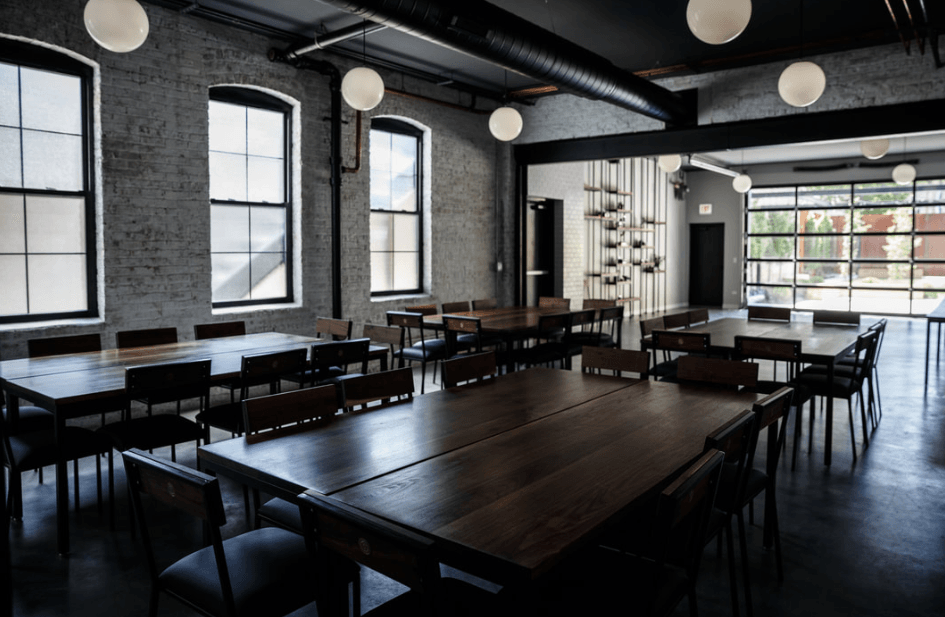 A large room with tables and chairs in it.