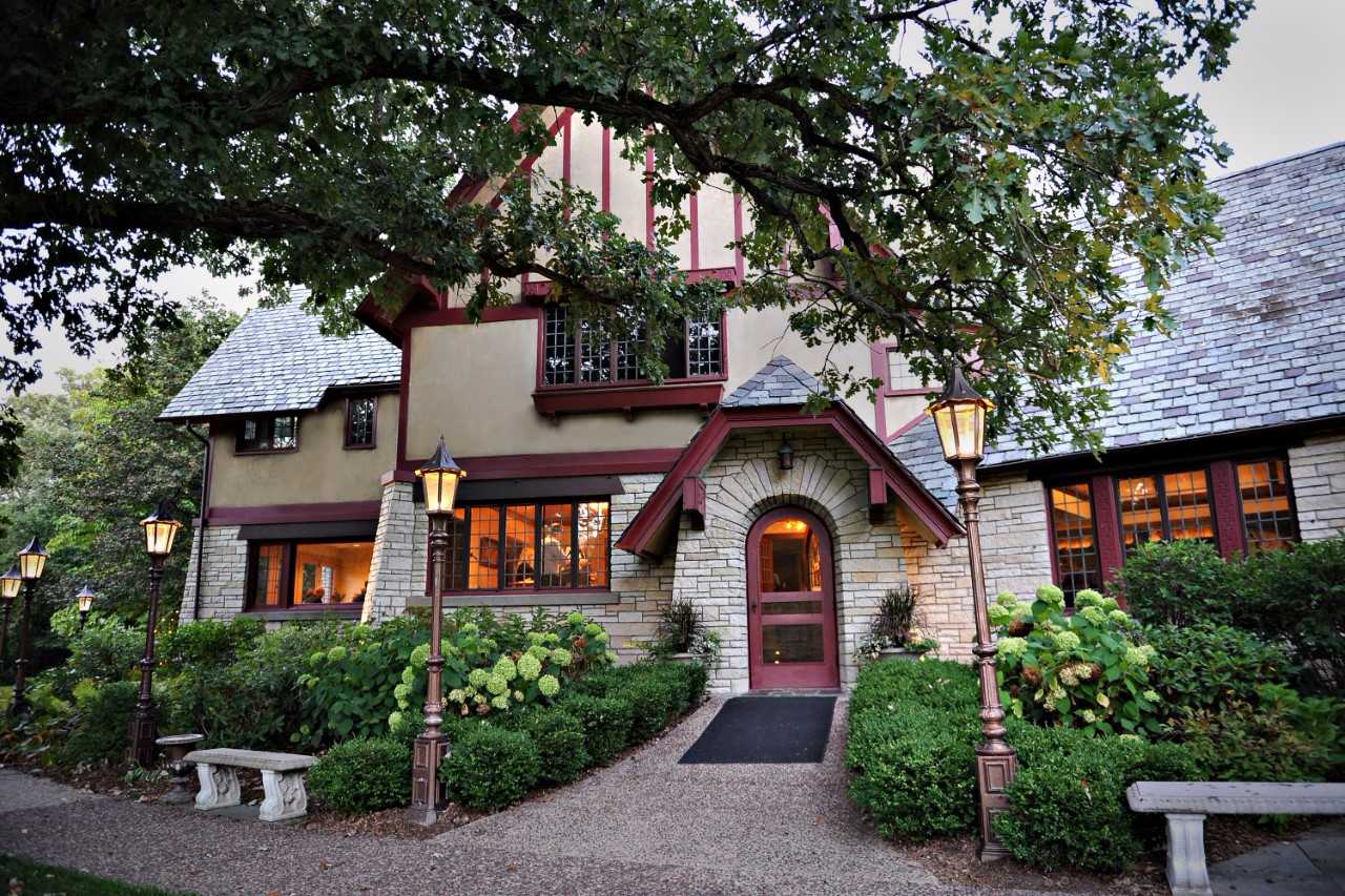 A large house with a lot of windows and trees in front of it
