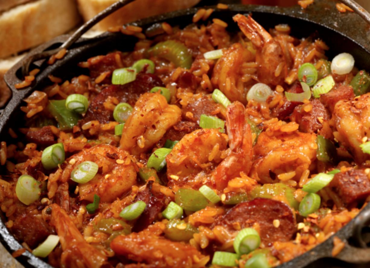 large pot filled with rice, sausage, and shrimp jambalaya. 