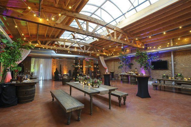 A large room with tables and benches and a skylight.