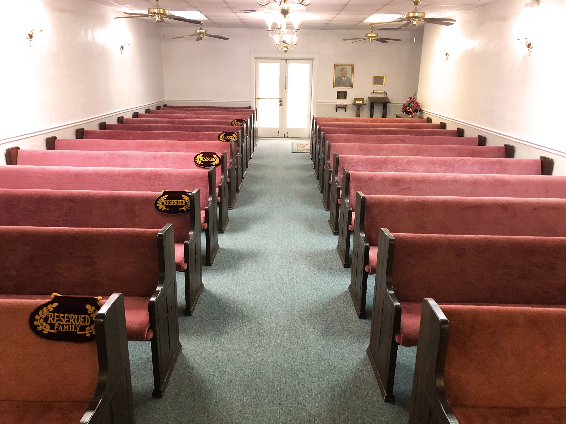Rows of pink benches in an empty church