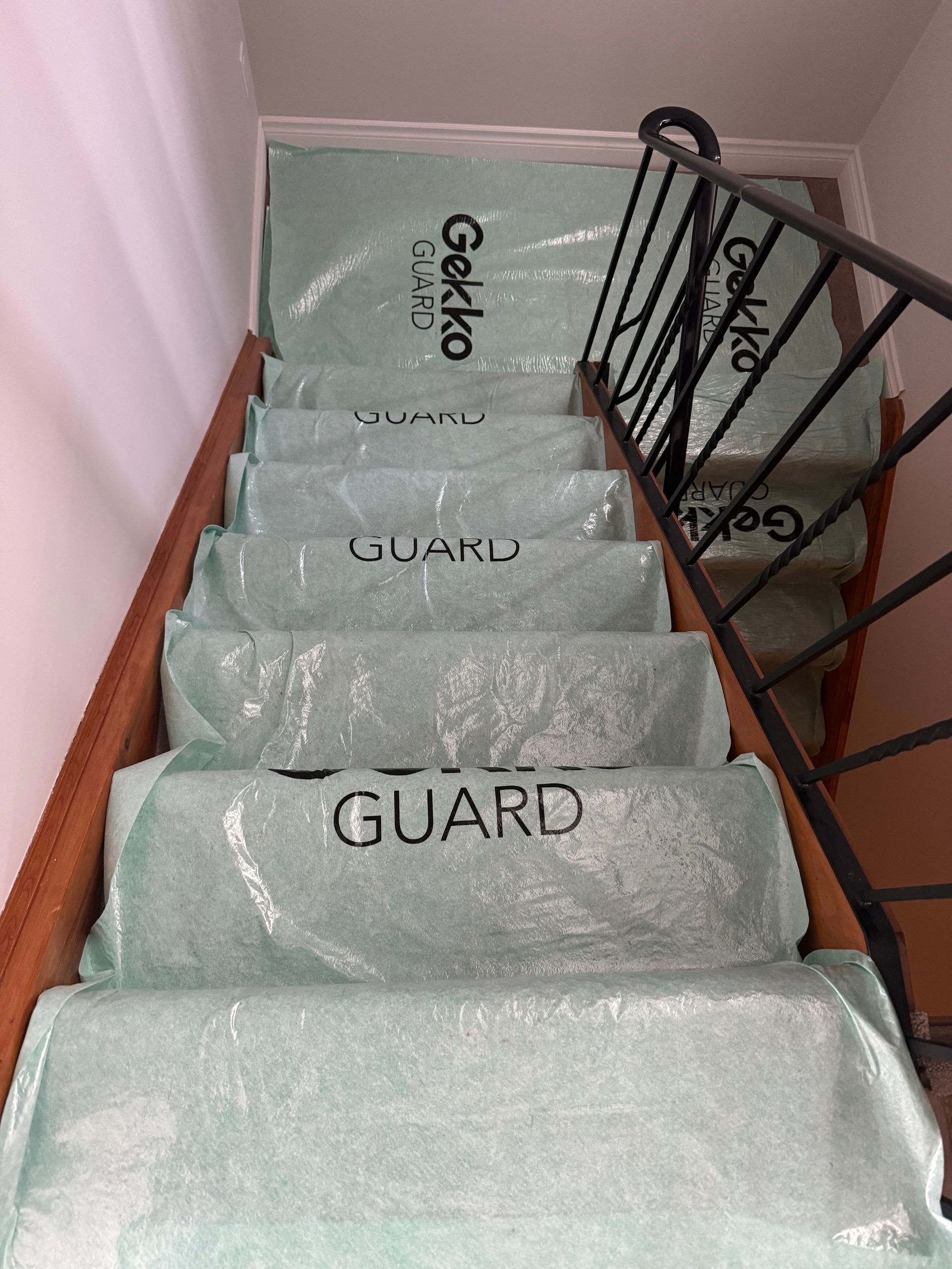Staircase with steps covered in protective green plastic with 