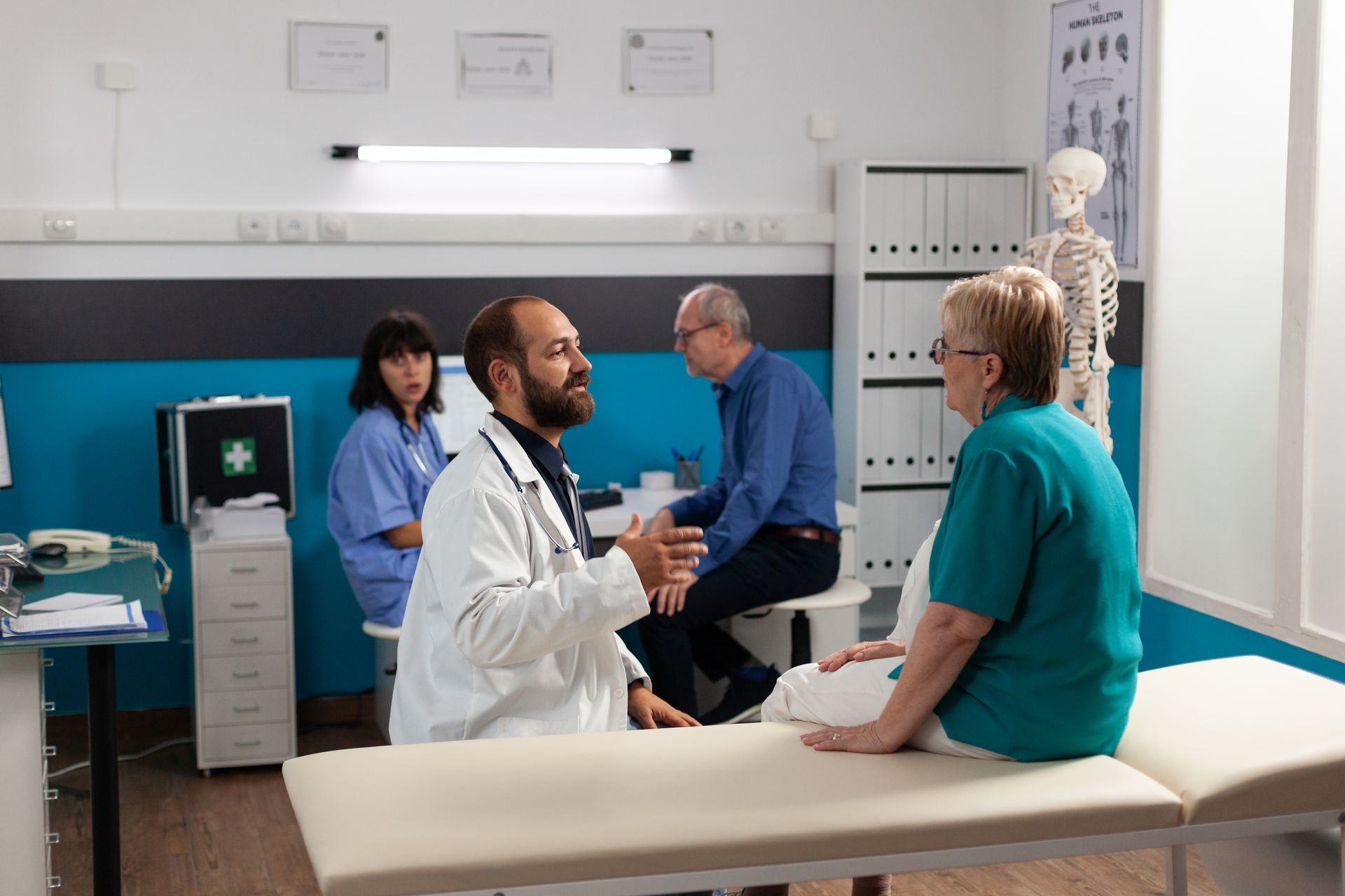 A doctor is talking to a patient in a hospital room.