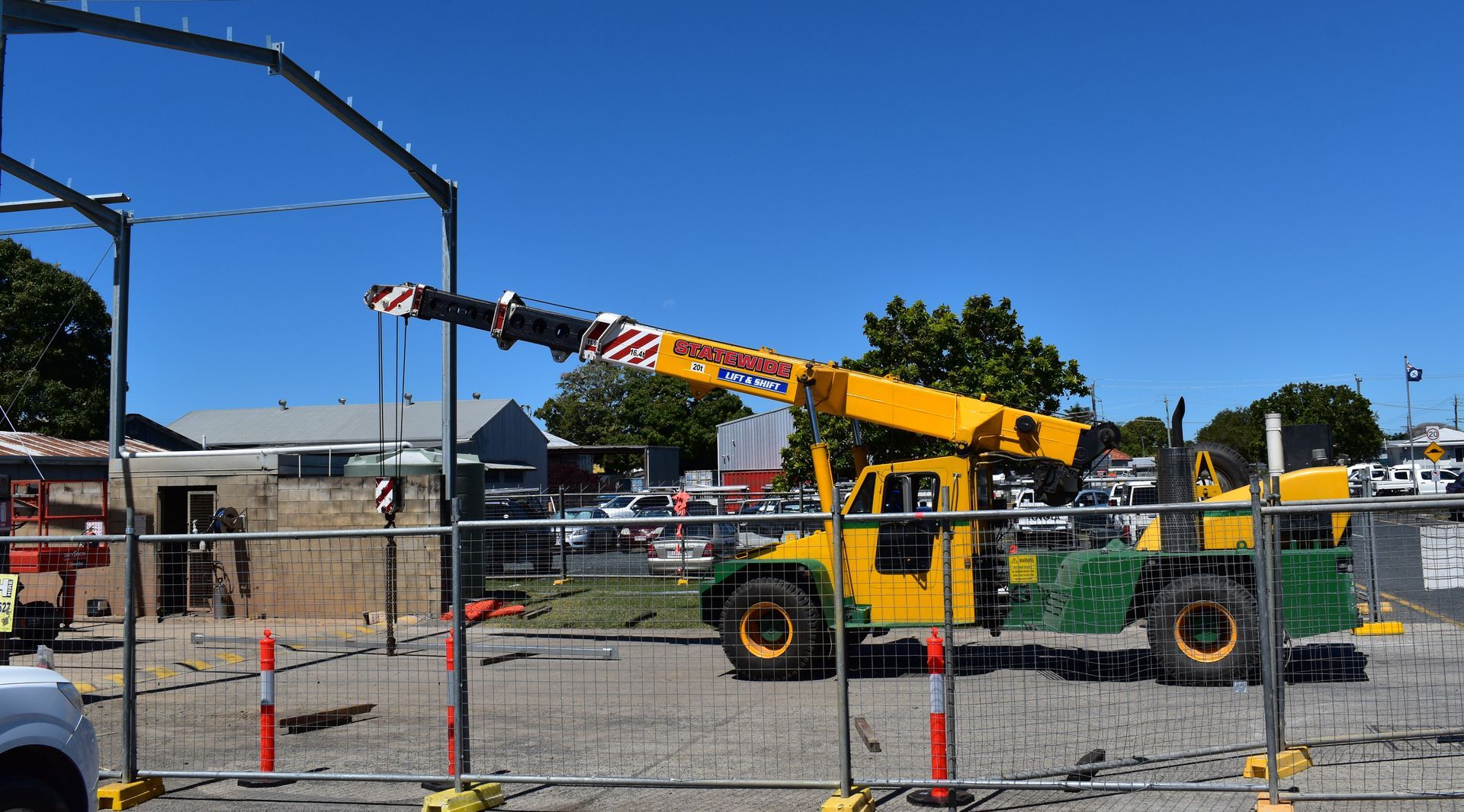Yellow crane at a construction site on a sunny day — Statewide Lift & Shift Pty Ltd In Paget, QLD