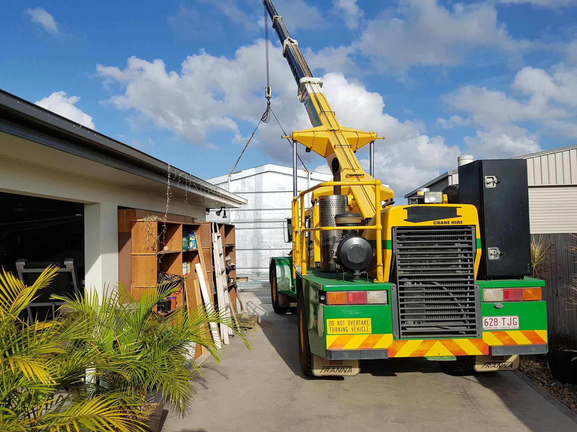 Yellow crane lifting, near building — Statewide Lift & Shift Pty Ltd In Sarina, QLD