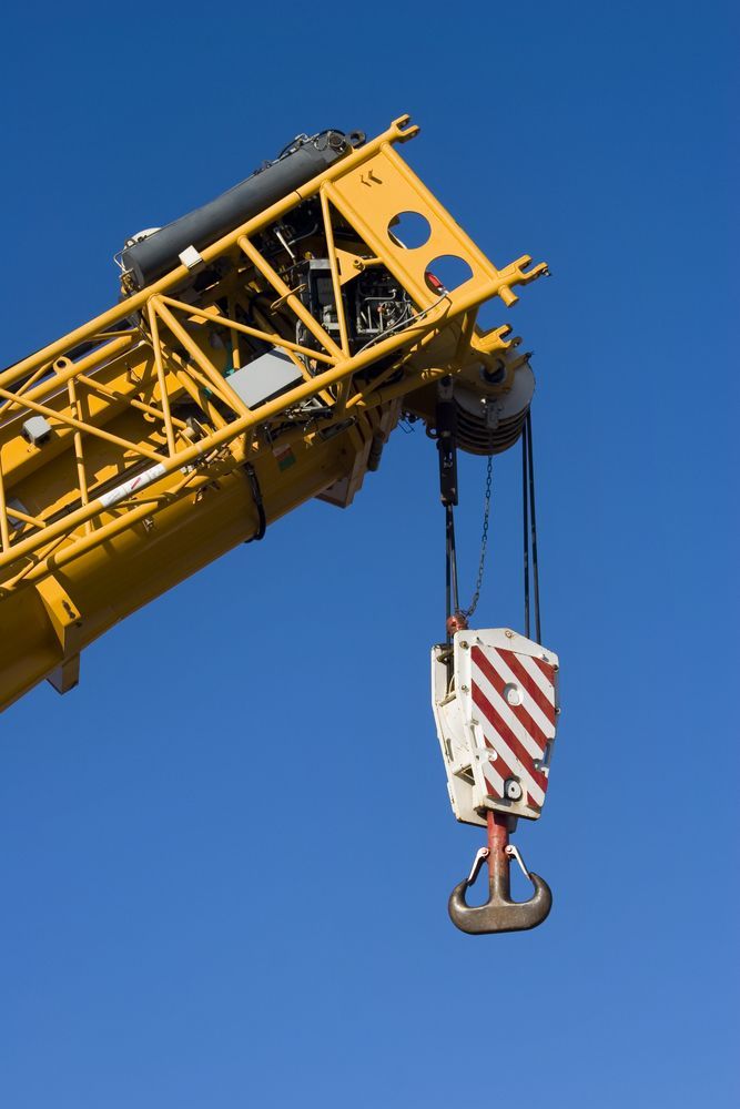 Yellow Construction Crane Against a Clear Blue Sky — Statewide Lift & Shift Pty Ltd In Bowen, QLD
