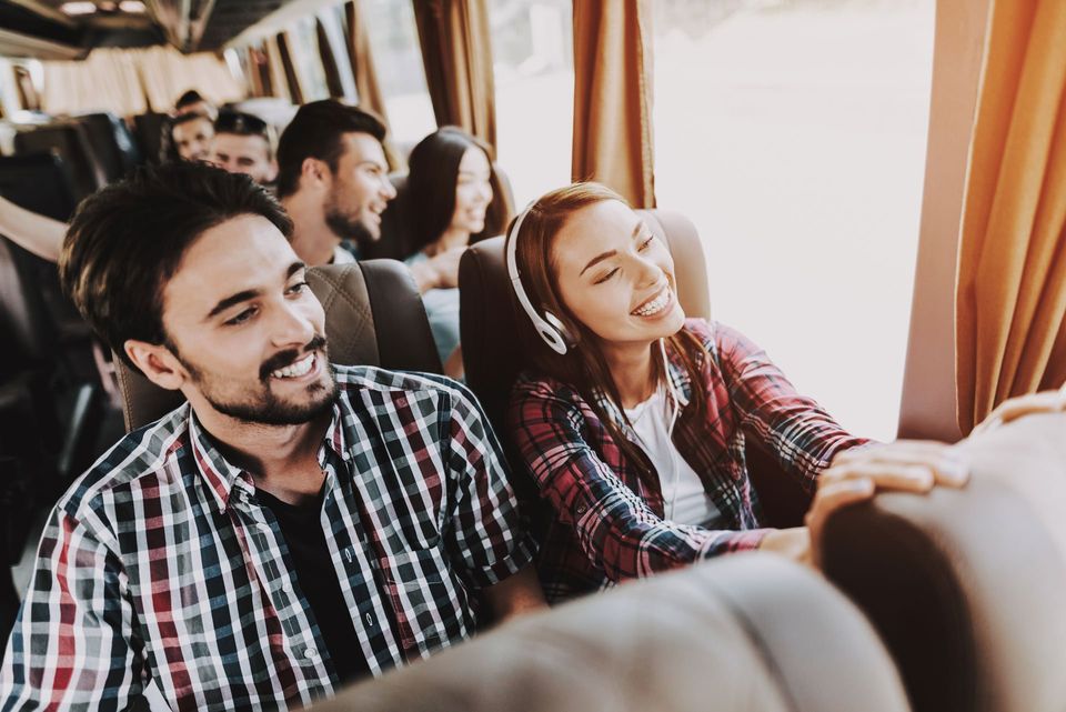 Young Smiling Couple Traveling — Greenville, SC — Jean's Bus Service, Inc.