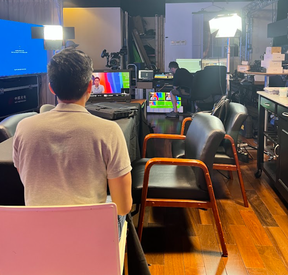 A man is sitting in a chair in front of a television
