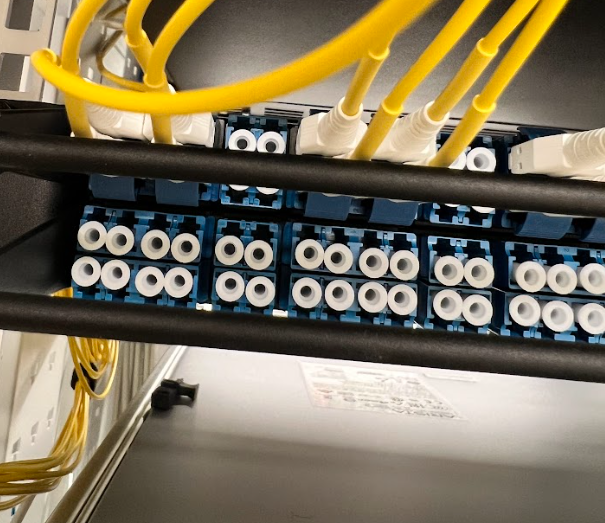 A bunch of wires are connected to a shelf that says 00 on it