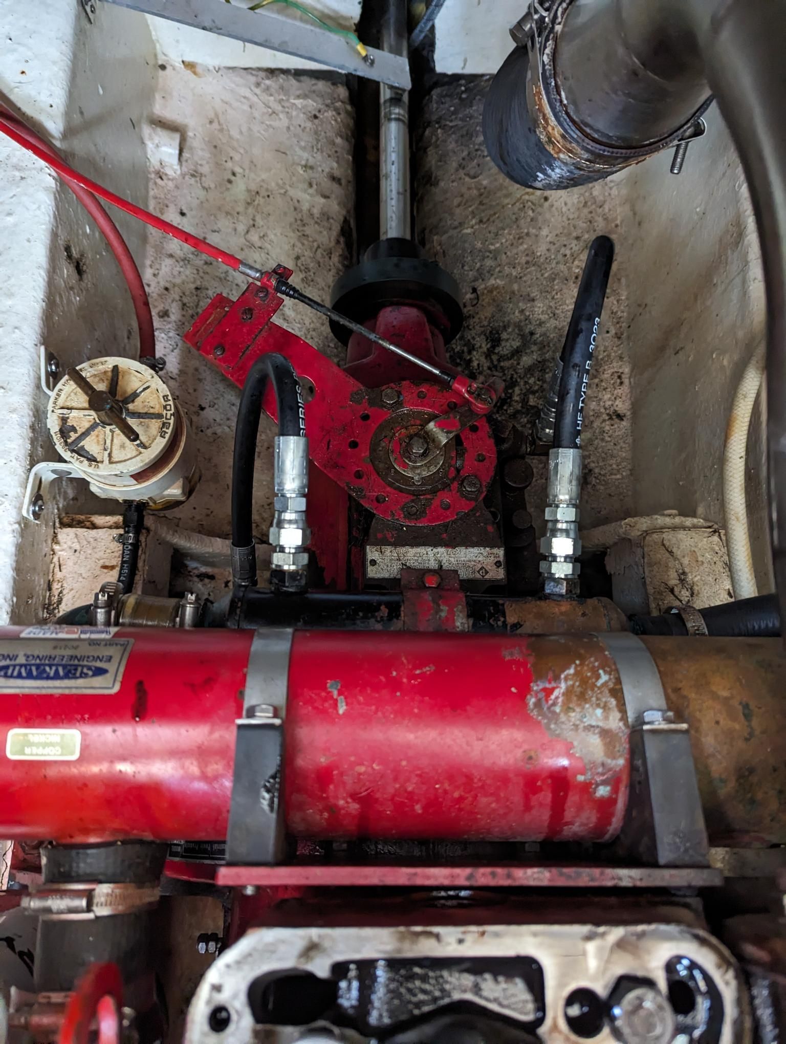 A Hand Holds a Fuel Container With a Hose Running Into a Marine Engine — Symbiote Systems in Airlie Beach, QLD