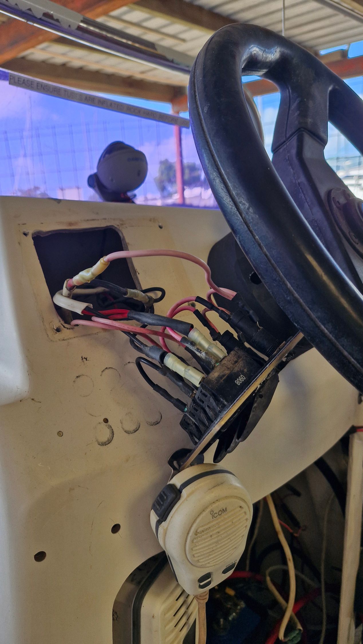 Boat Console With Exposed Wiring, Steering Wheel, and Radio — Symbiote Systems in Airlie Beach, QLD