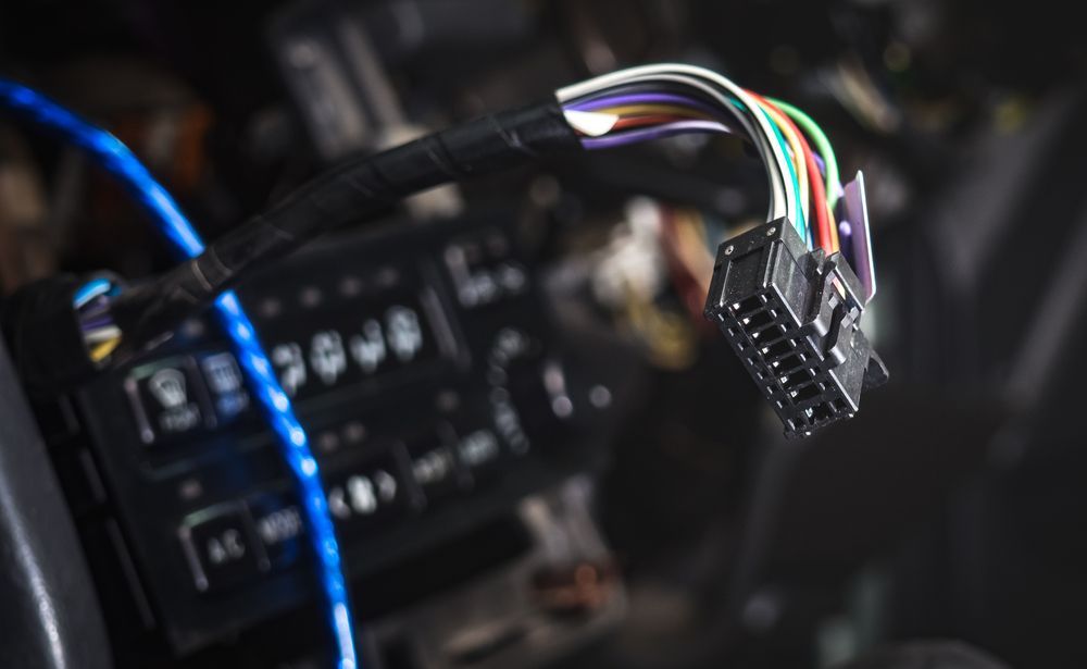 Black Car Stereo Wiring Harness With Multiple Coloured Wires — Symbiote Systems in Airlie Beach, QLD
