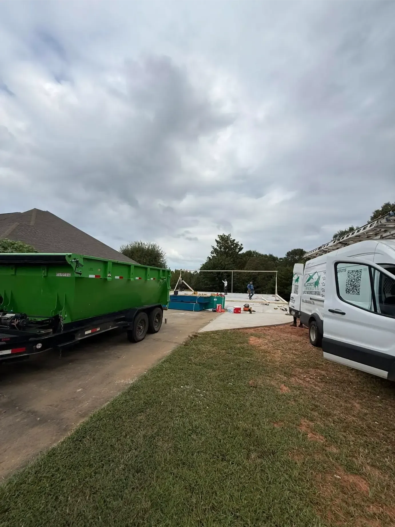 Patio with outdoor furniture on a stone patio, lush garden, sunny day.
