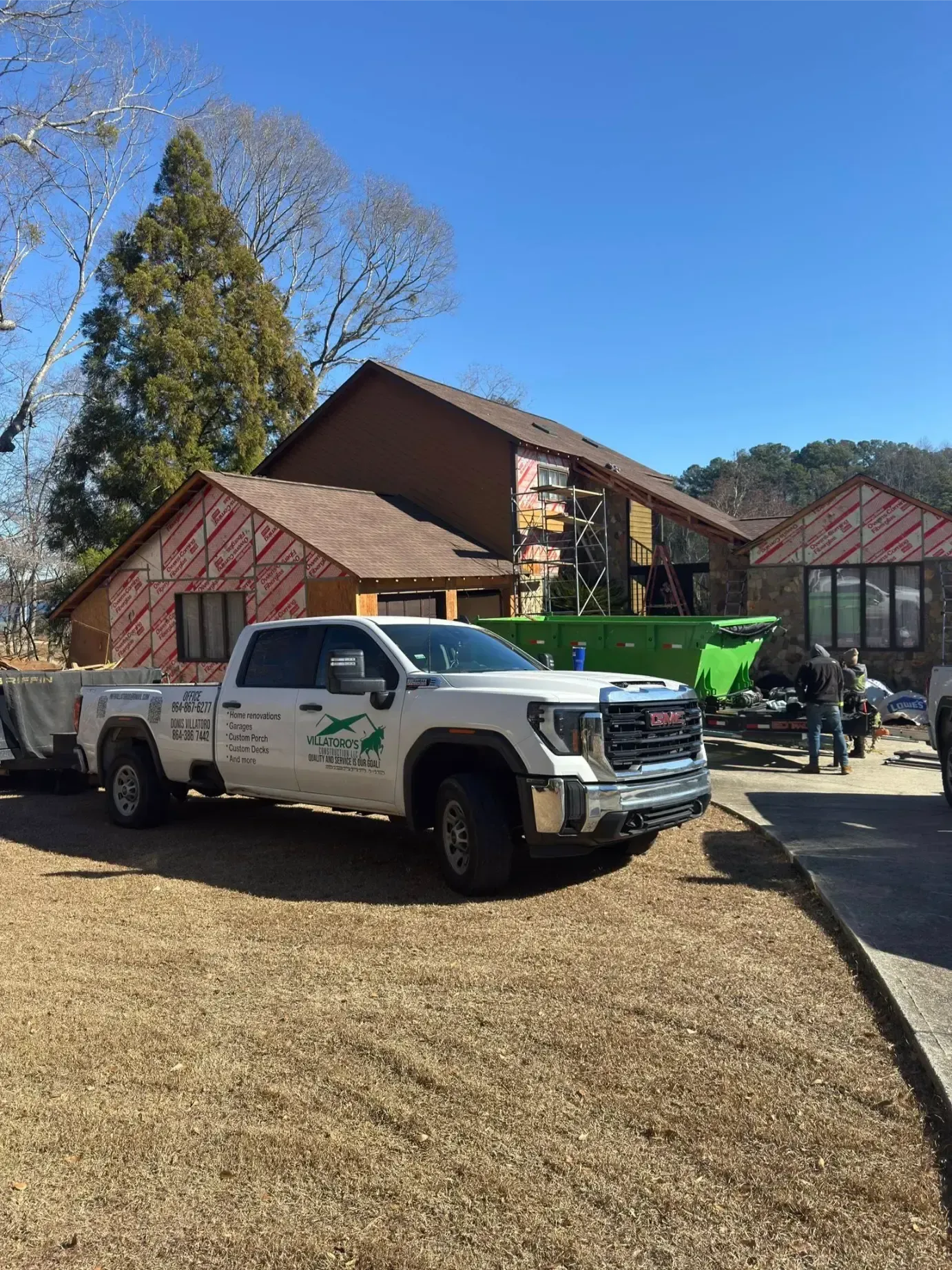 Outdoor deck with pergola, seating area, and scenic view. Brown deck, furniture, and pergola.
