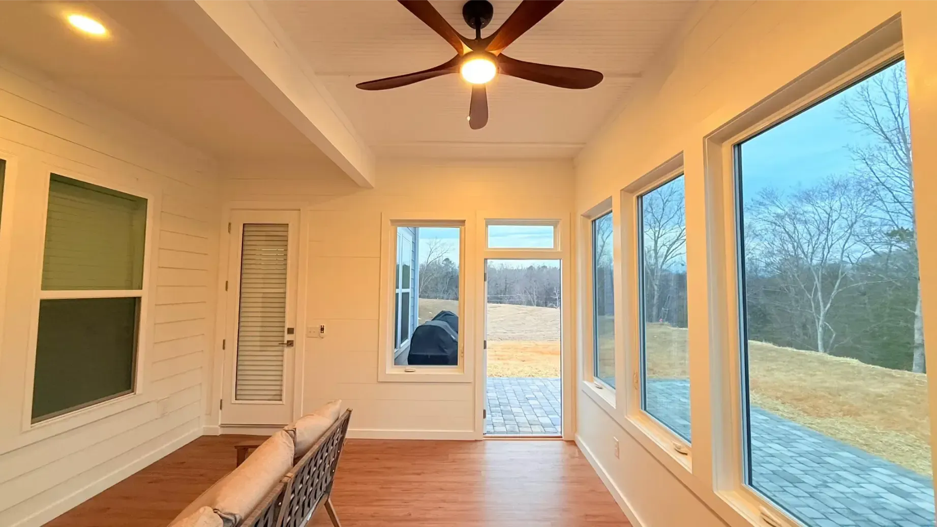 Two people installing kitchen cabinets; one on a step ladder, another at the counter.
