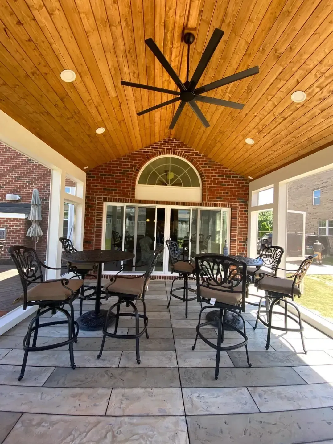 Patio with stone steps, fire pit, covered porch, pergola, and outdoor seating.