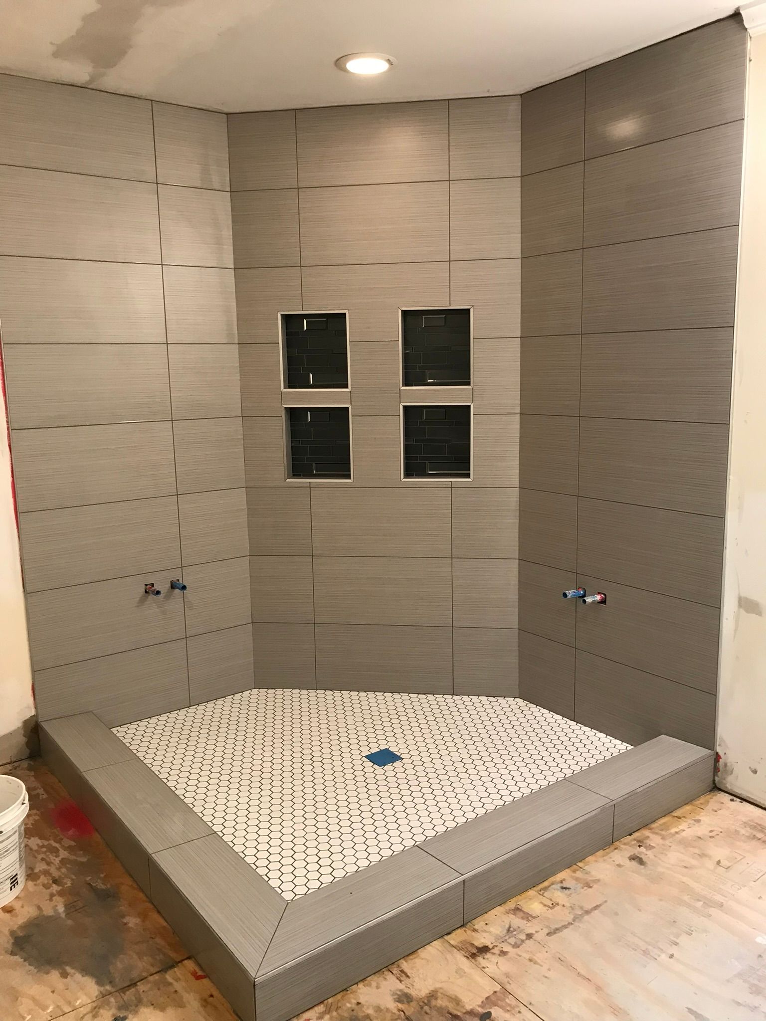 A shower stall is being built in a bathroom