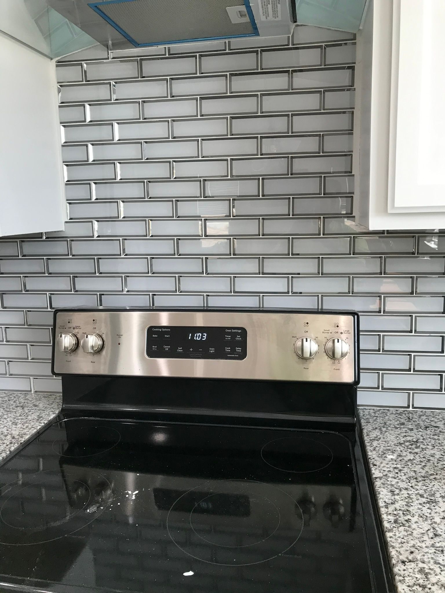 A stainless steel stove top oven with a black burner
