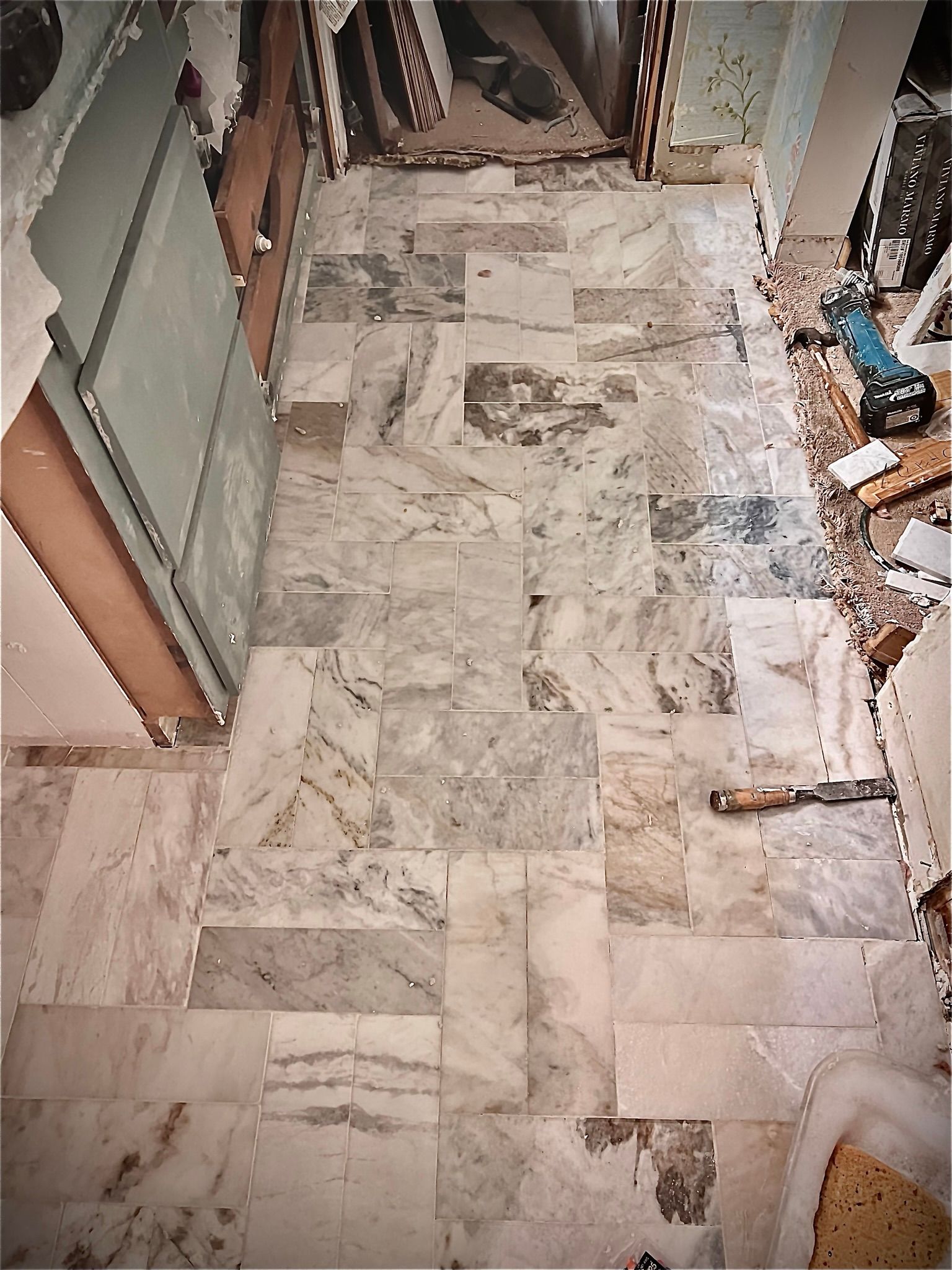 A marble floor in a room with a hammer on it