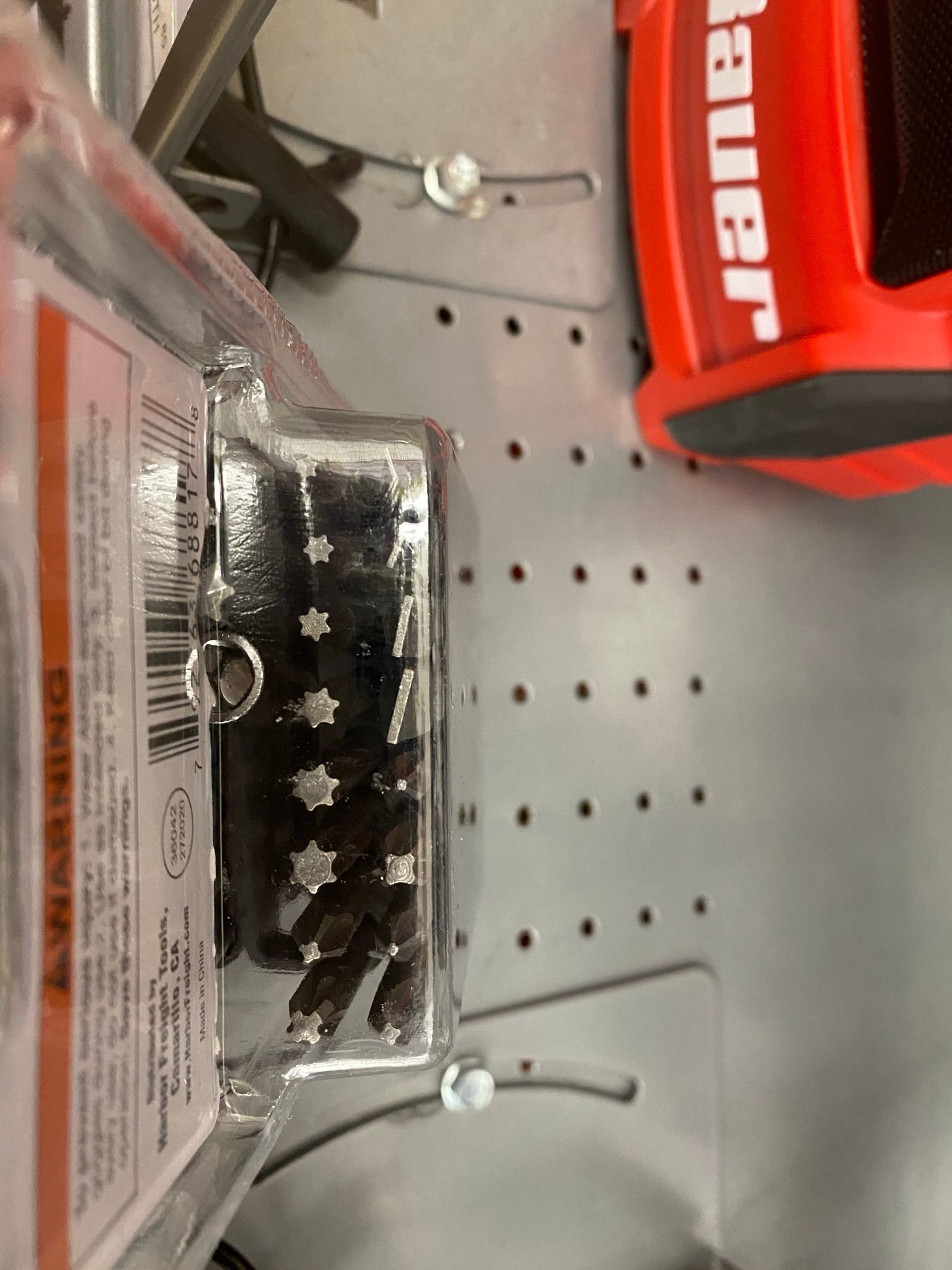 A red bauer box sits next to a package of brushes