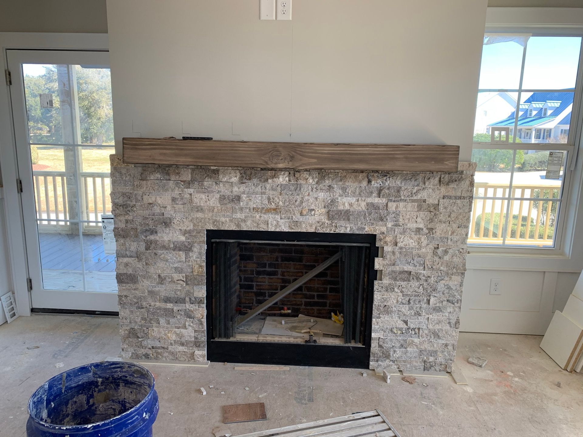 A living room with a fireplace and a window