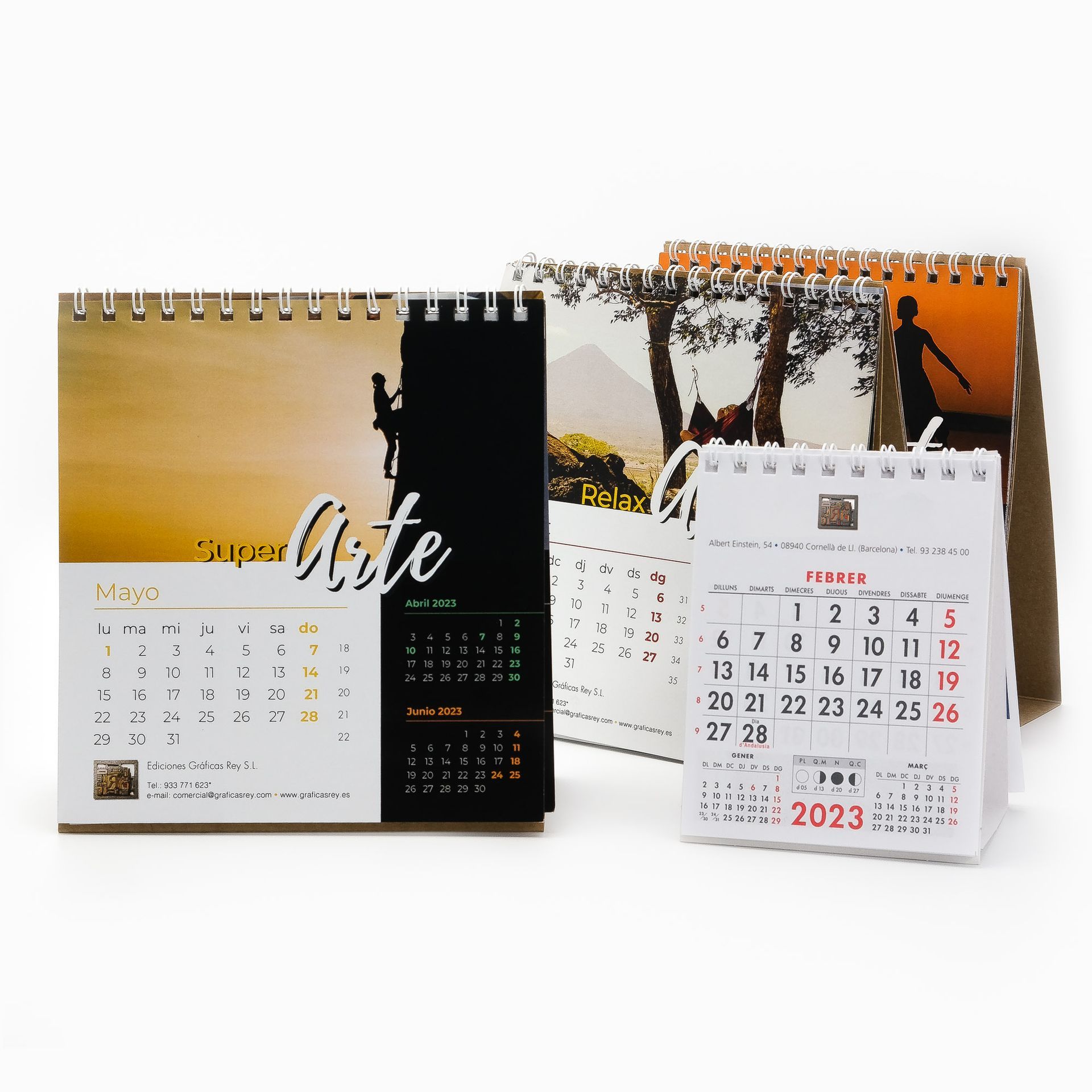 Desk calendars with spiral binding and various designs; one calendar visible for 2023.