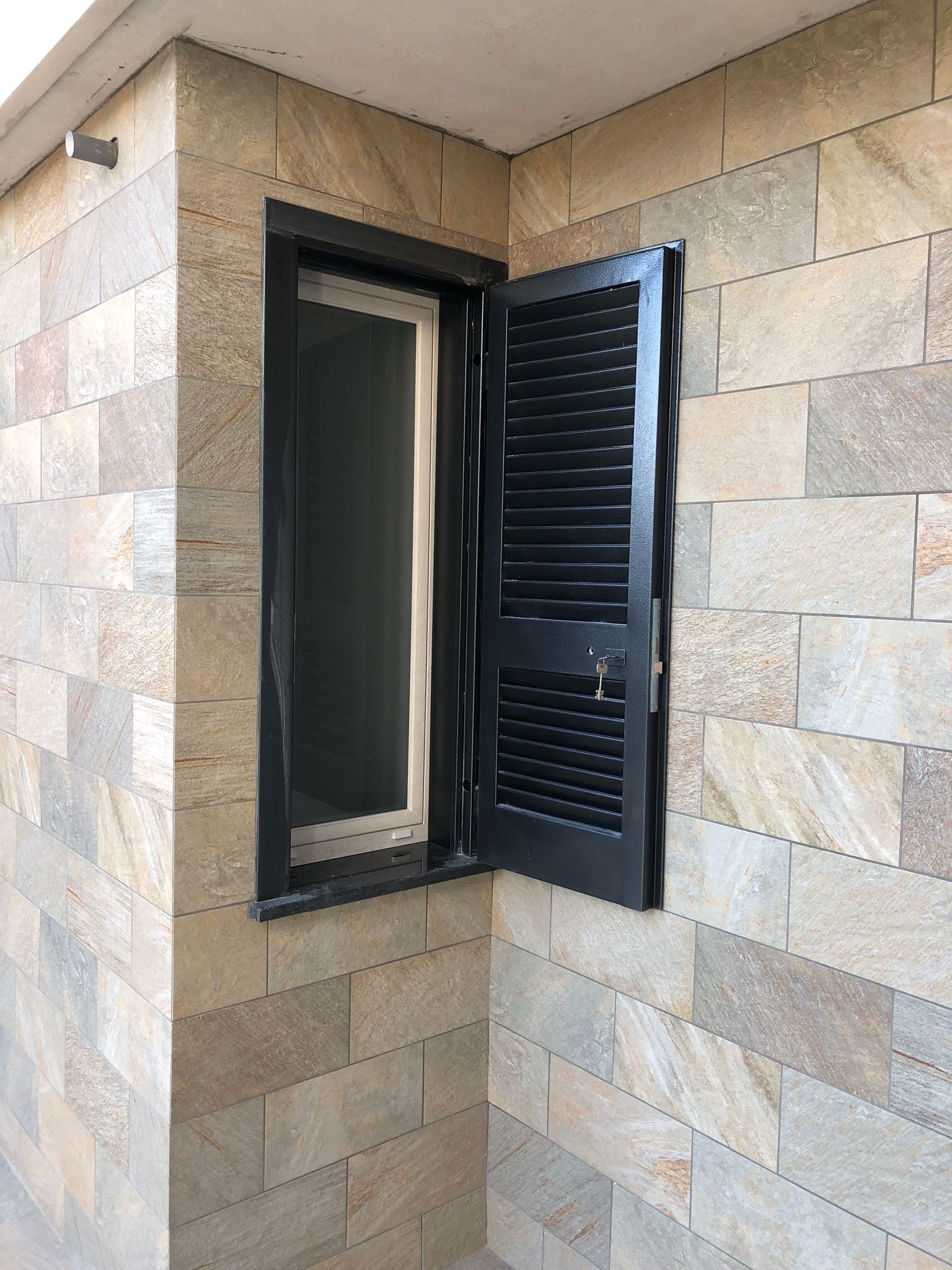 finestrino con infissi in PVC e persiane