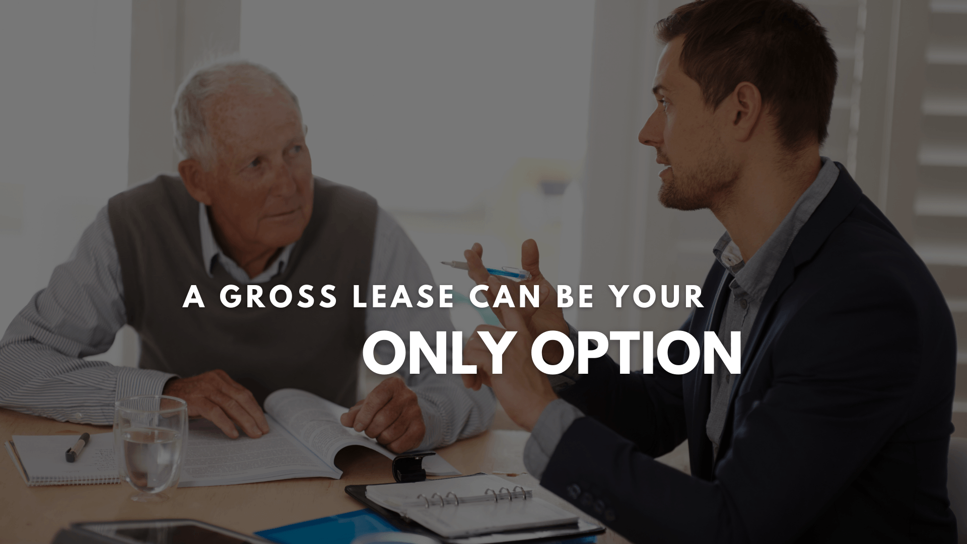 Two persons review the gross lease details