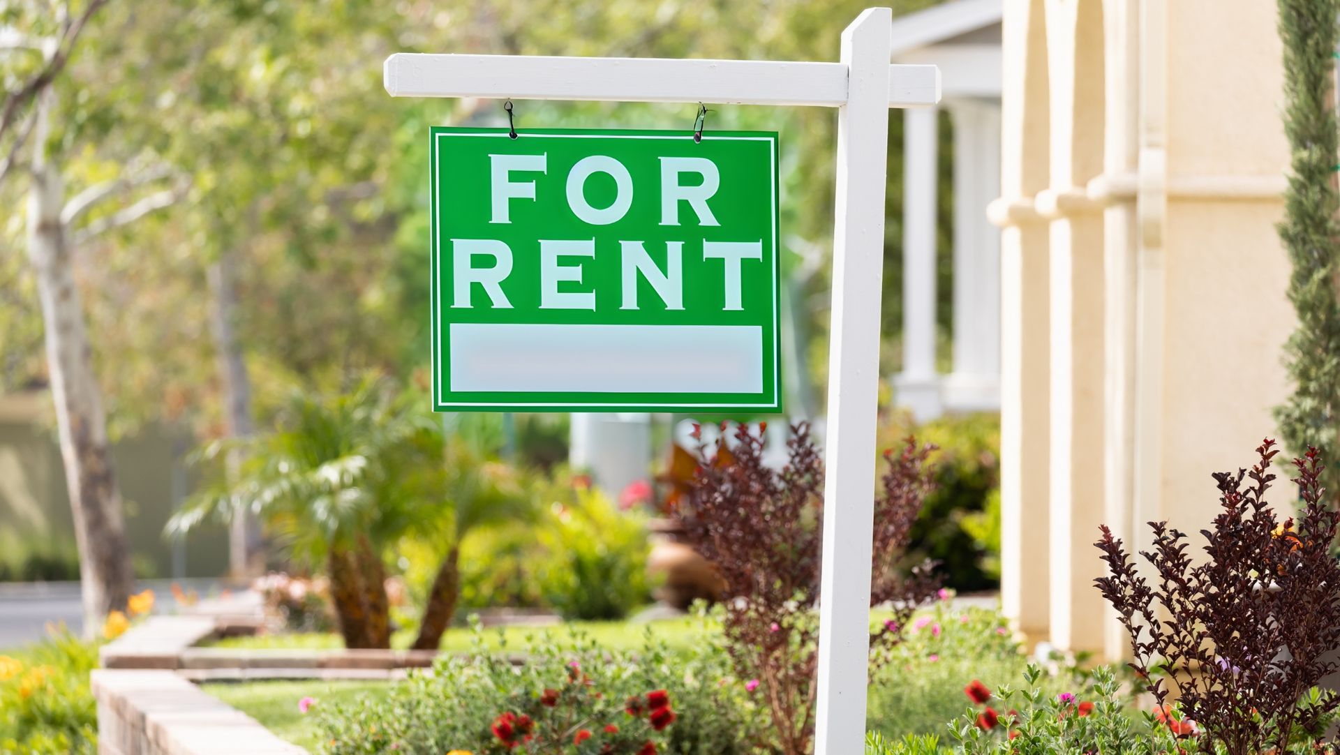 For rent sign displayed in front of a residential property, signaling availability in a welcoming neighborhood.