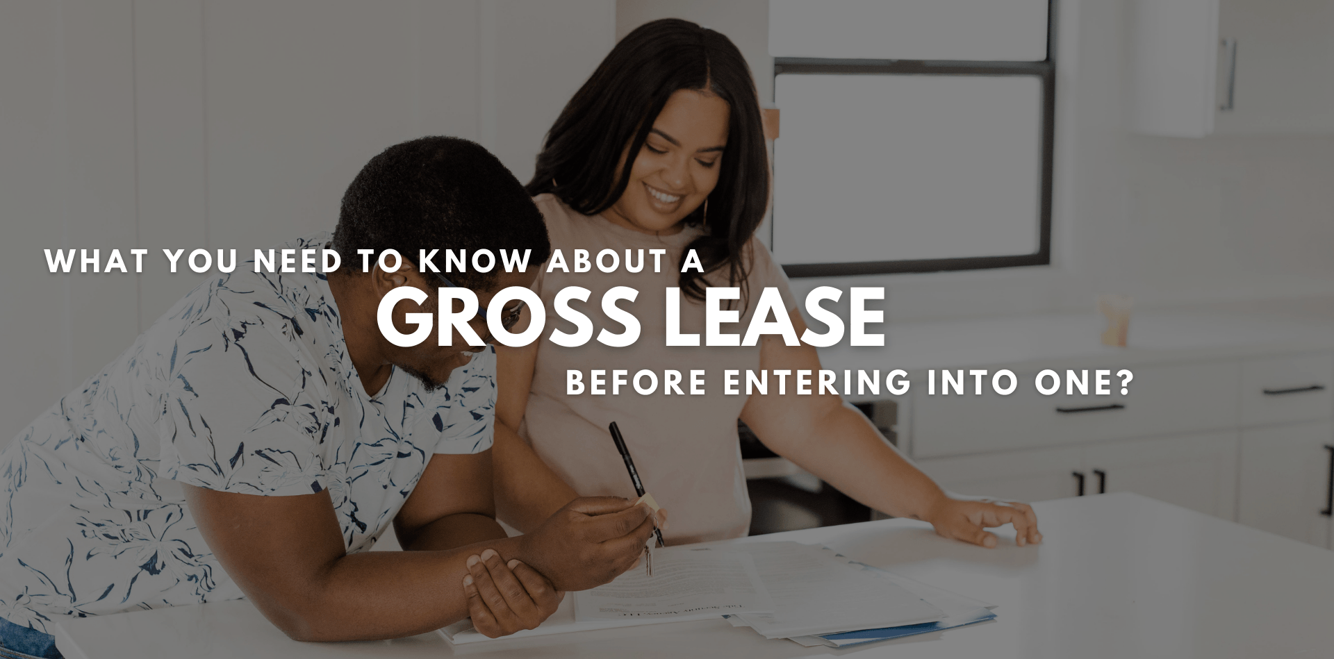 Man and a woman reviewing a gross lease to be signed.