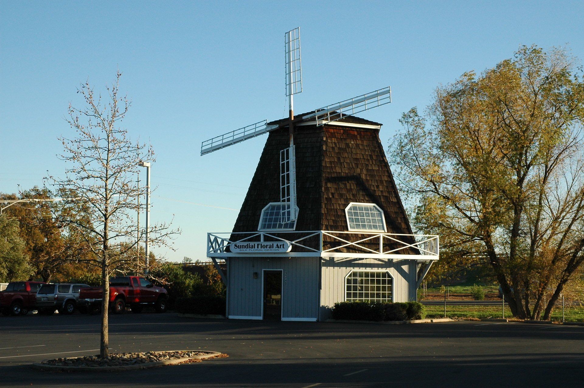 Palo Cedro, CA - Rustic windmill-shaped building houses Sentinel Federal Credit Union in parking lot under clear blue sky.