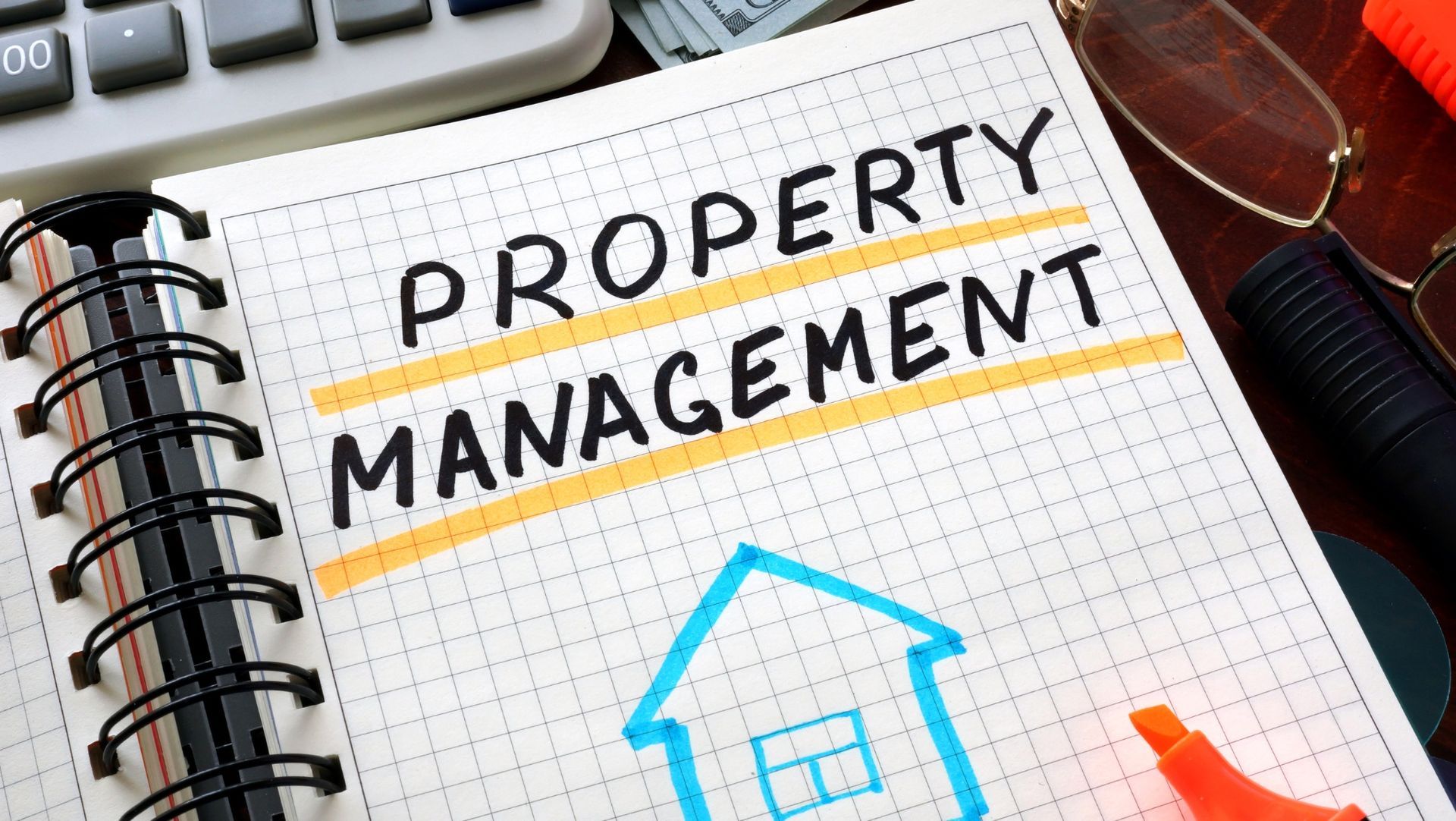 Notebook page with 'Property Management,' sketch of house, glasses, calculator, and currency suggesting real estate planning.
