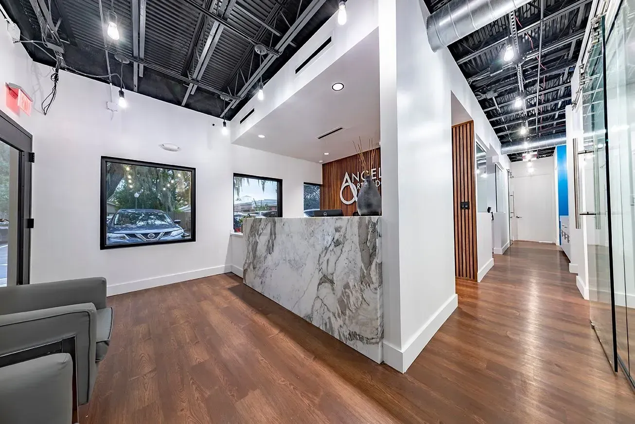 There is a marble counter in the middle of the room.