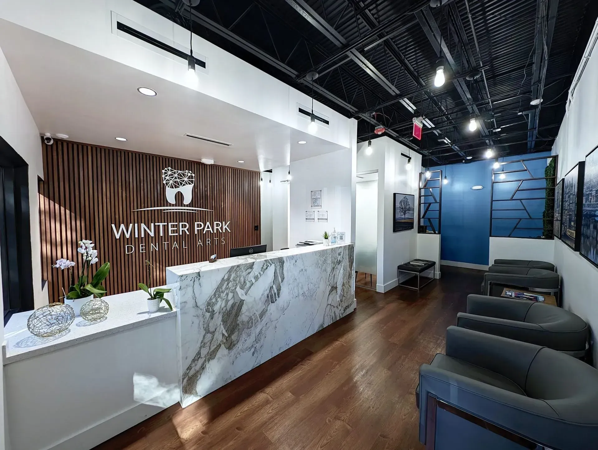 A dental office with a marble counter and chairs.